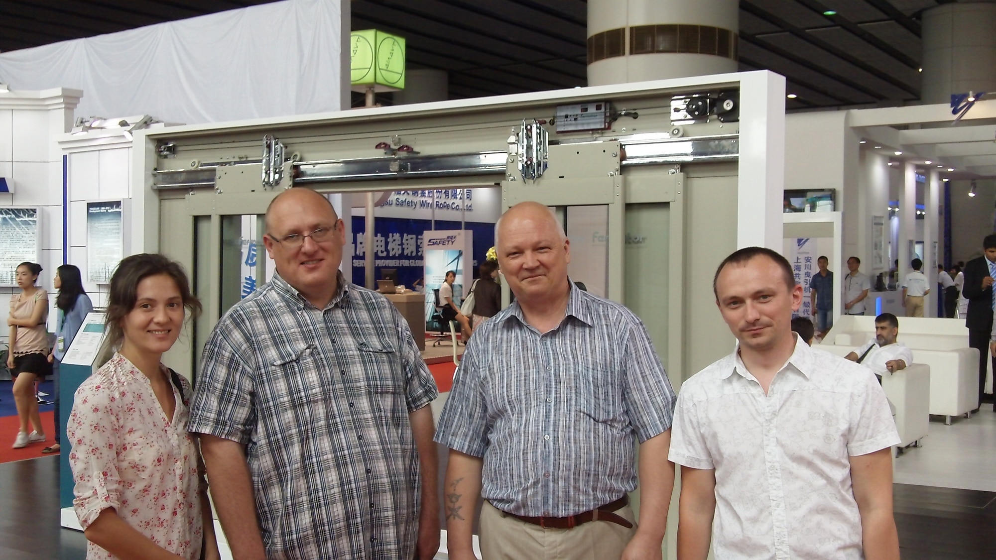 Anna with three clients at a trade fair in China