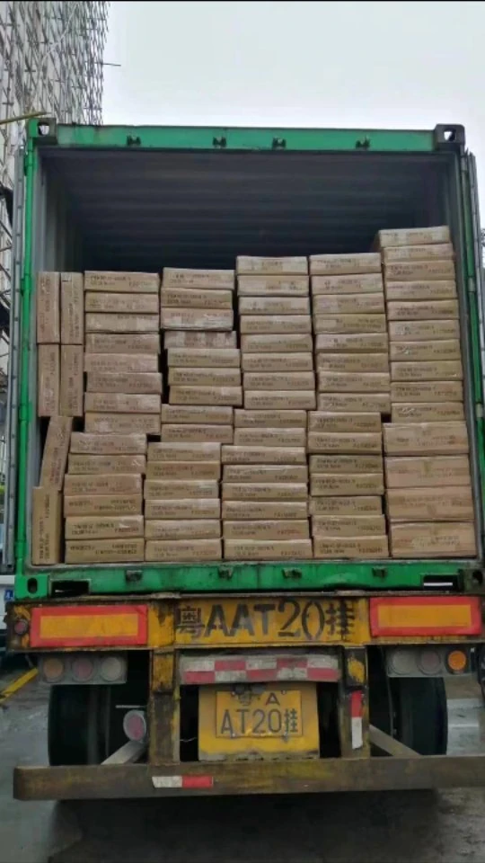 A shipping container loaded with stacked cartons