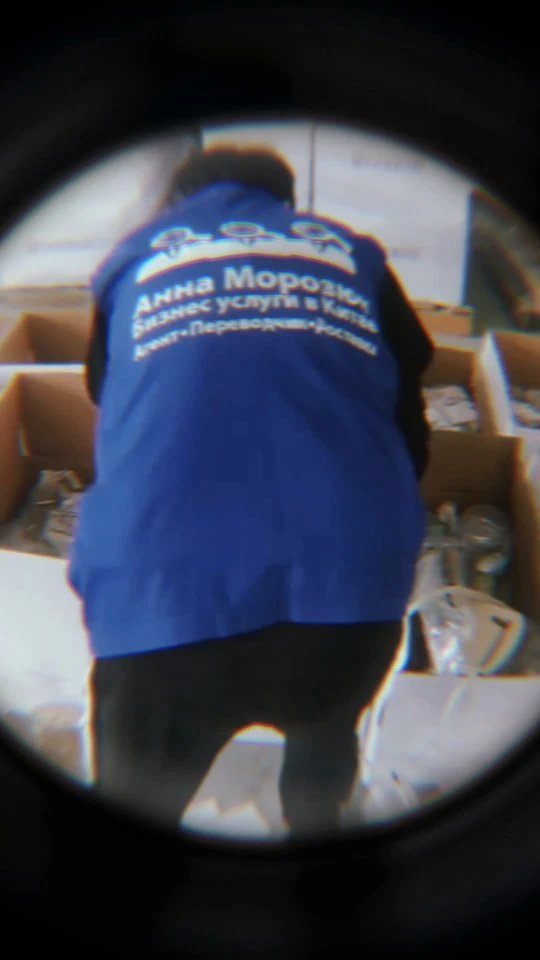 A team member in a blue company shirt inspecting goods